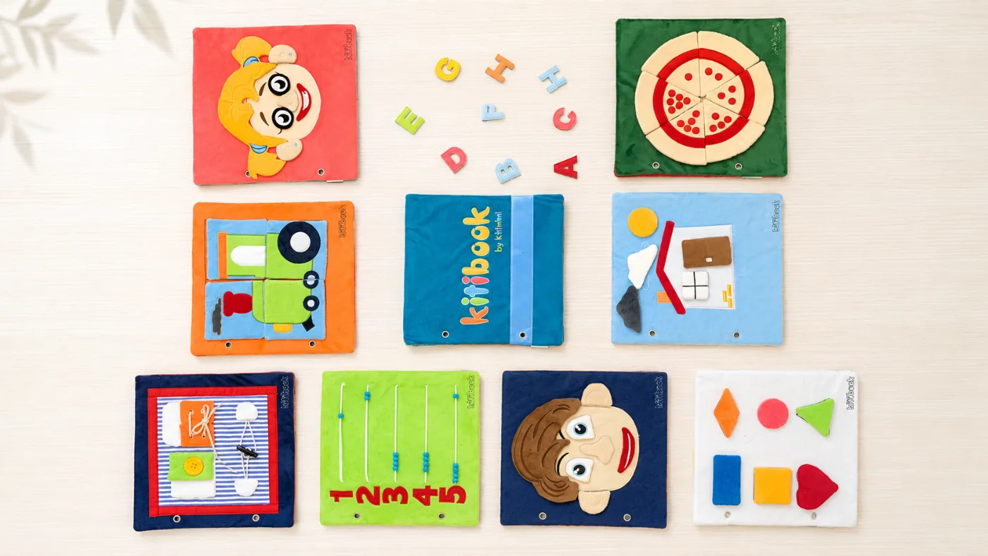Ensemble des planches d'activités Kitibook : visages, formes, chiffres, laçage, pizza, train, lettres — plusieurs activités dans un même livre