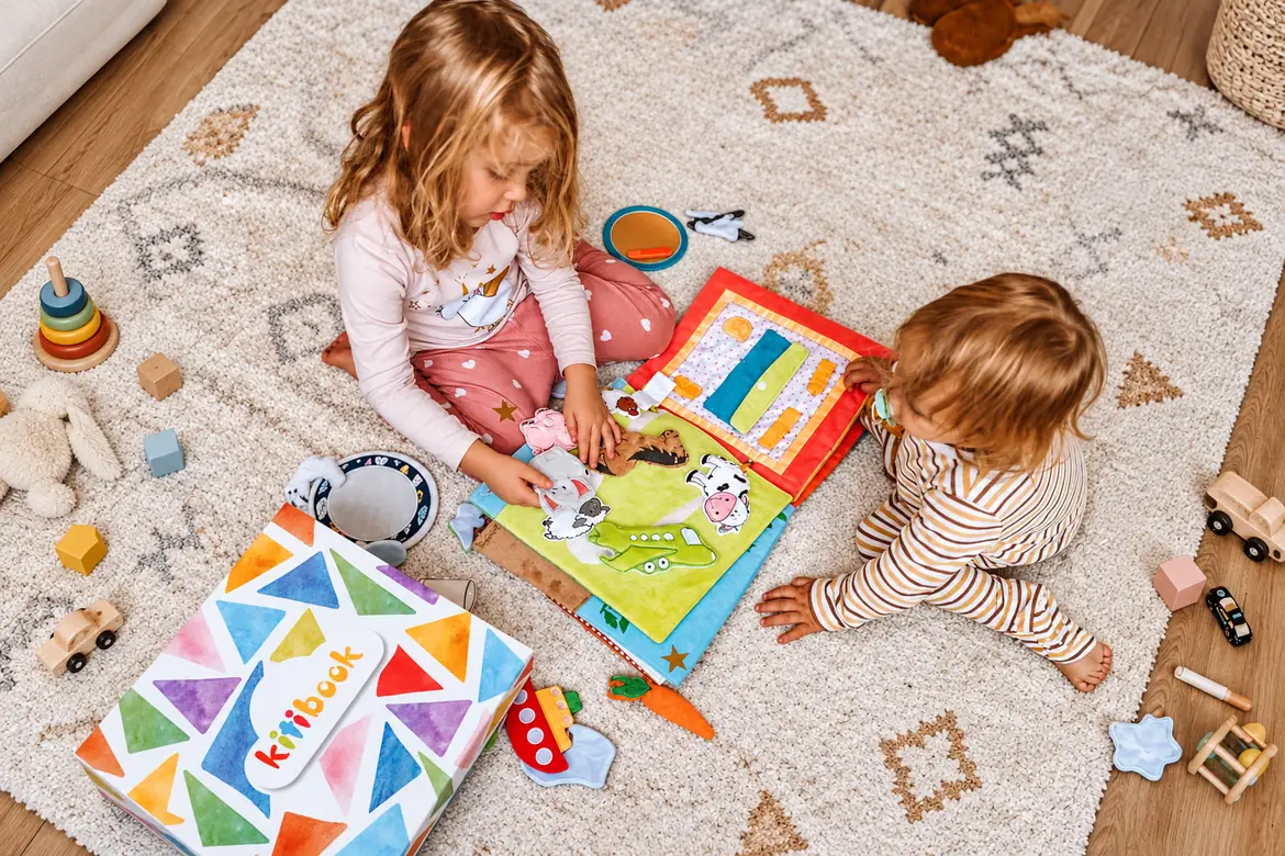 Two girls playing with the Kitibook